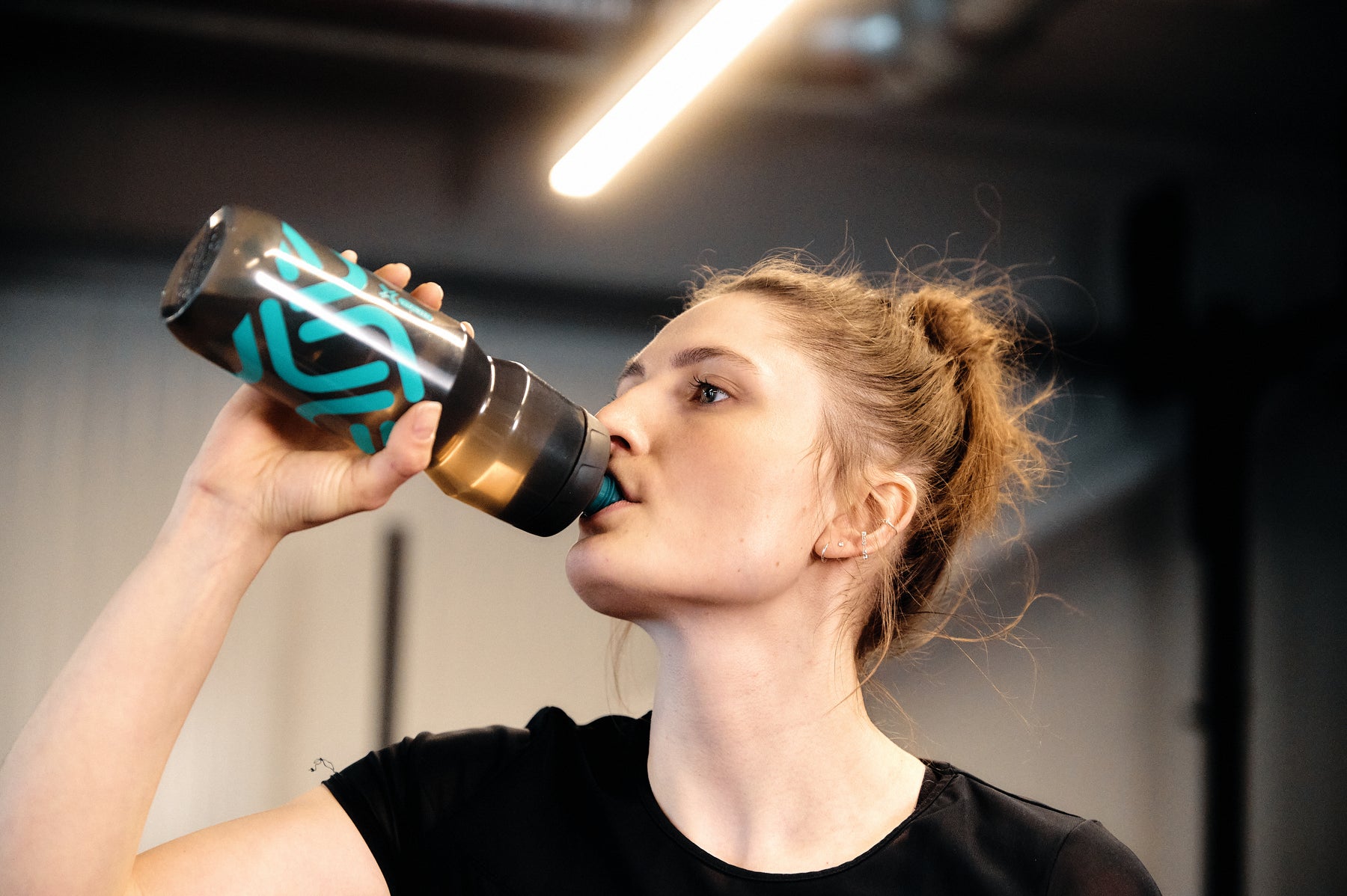 Woman drinking from Fidlock Fidguard 750ml Antibacterial Bottle