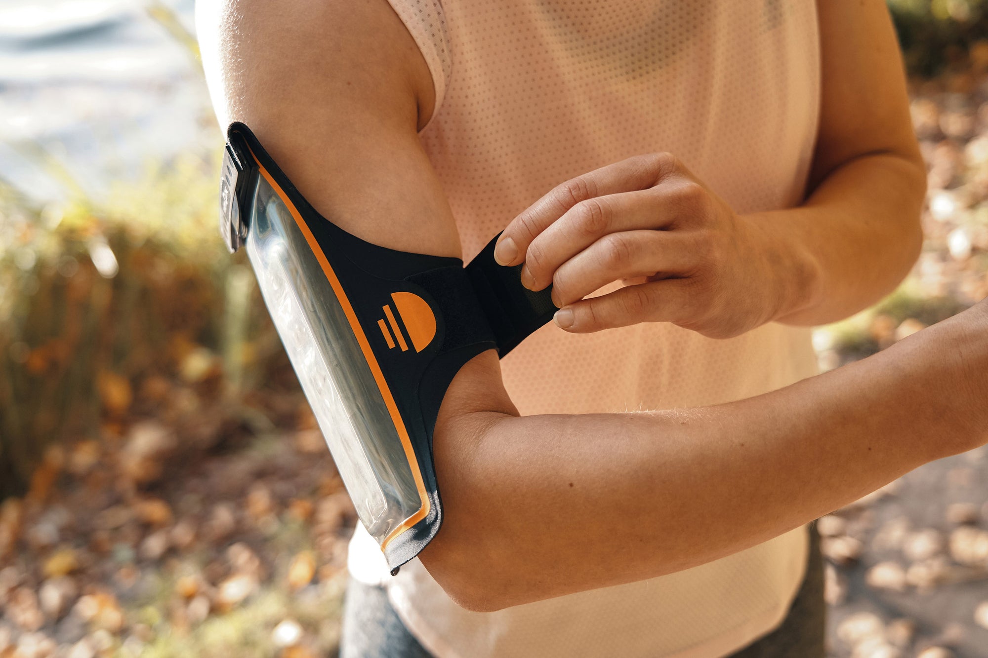 Woman attaching Fidlock Phone Arm Band