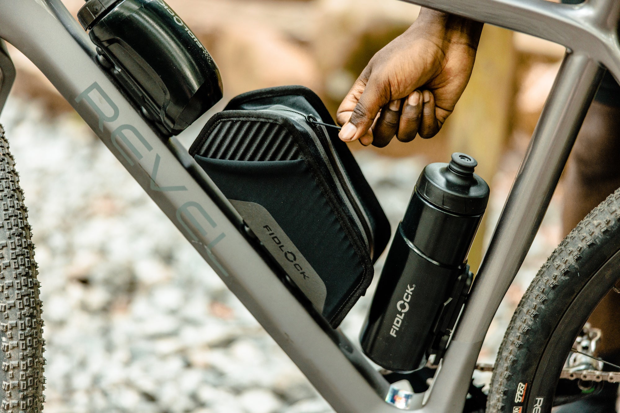 Fidlock water bottles and gear storage mounted to bicycle frame via magnetic/mechanically locking mechanisms