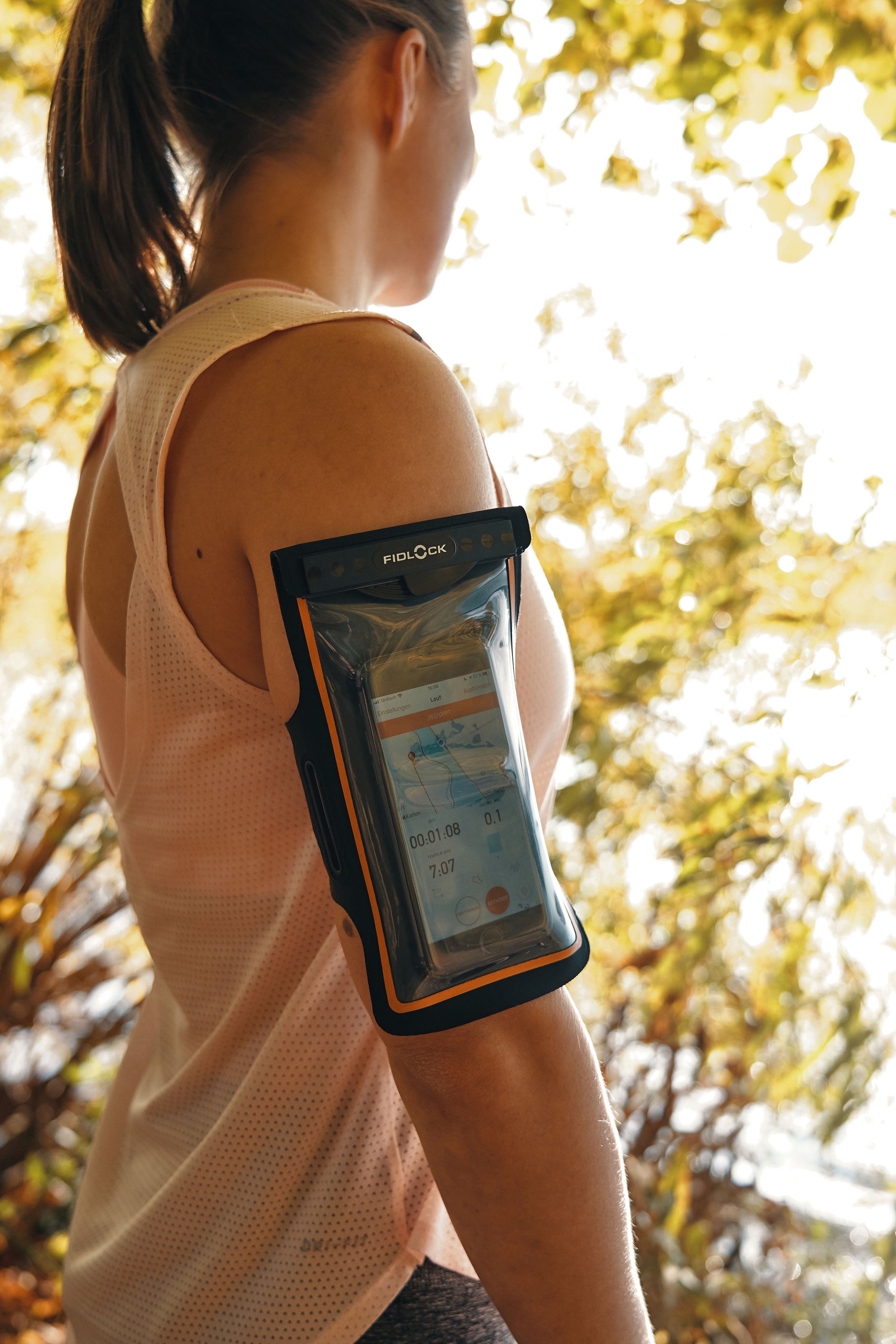 Woman wearing Fidlock Phone Arm Band