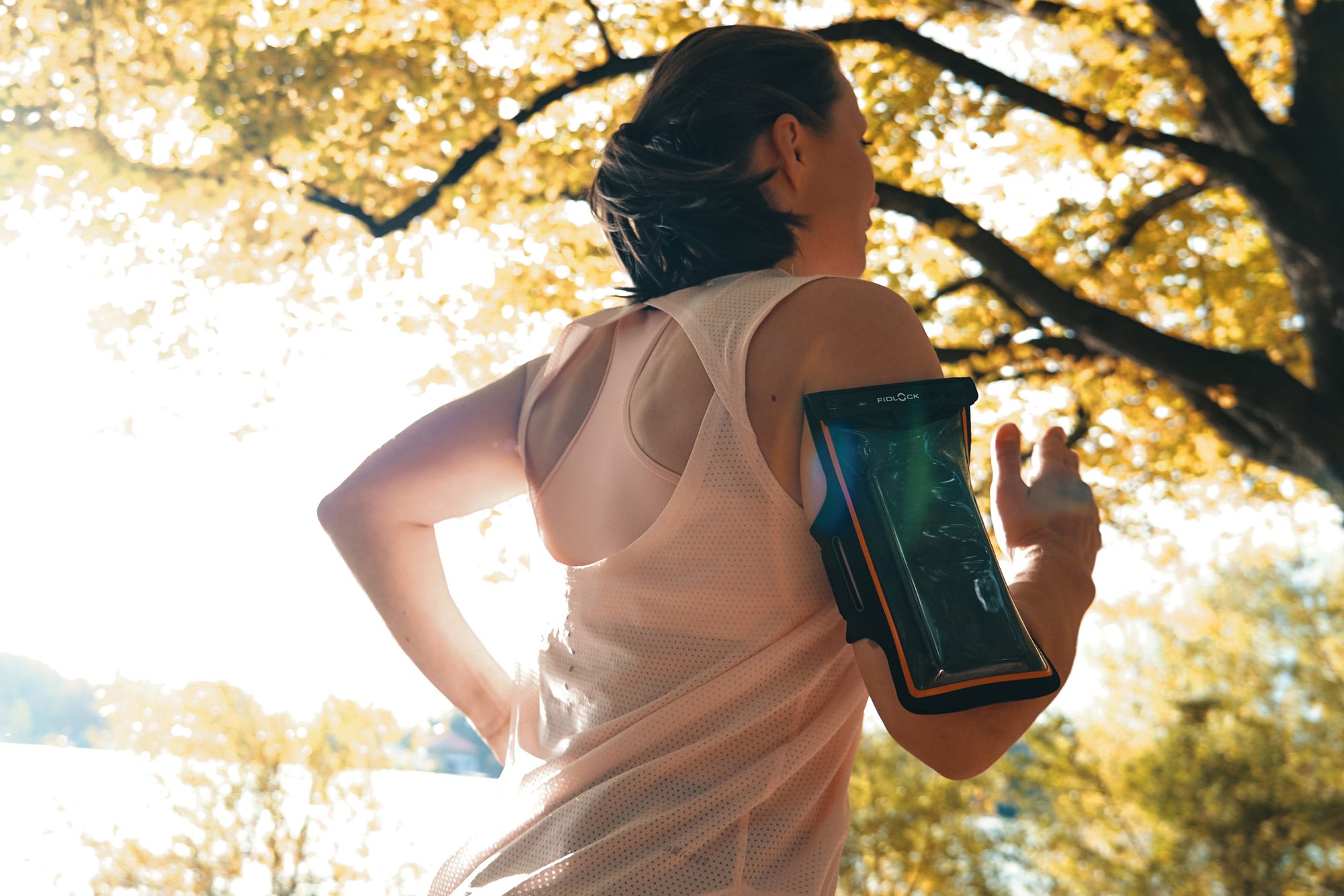 Woman wearing Fidlock Phone Arm Band while running