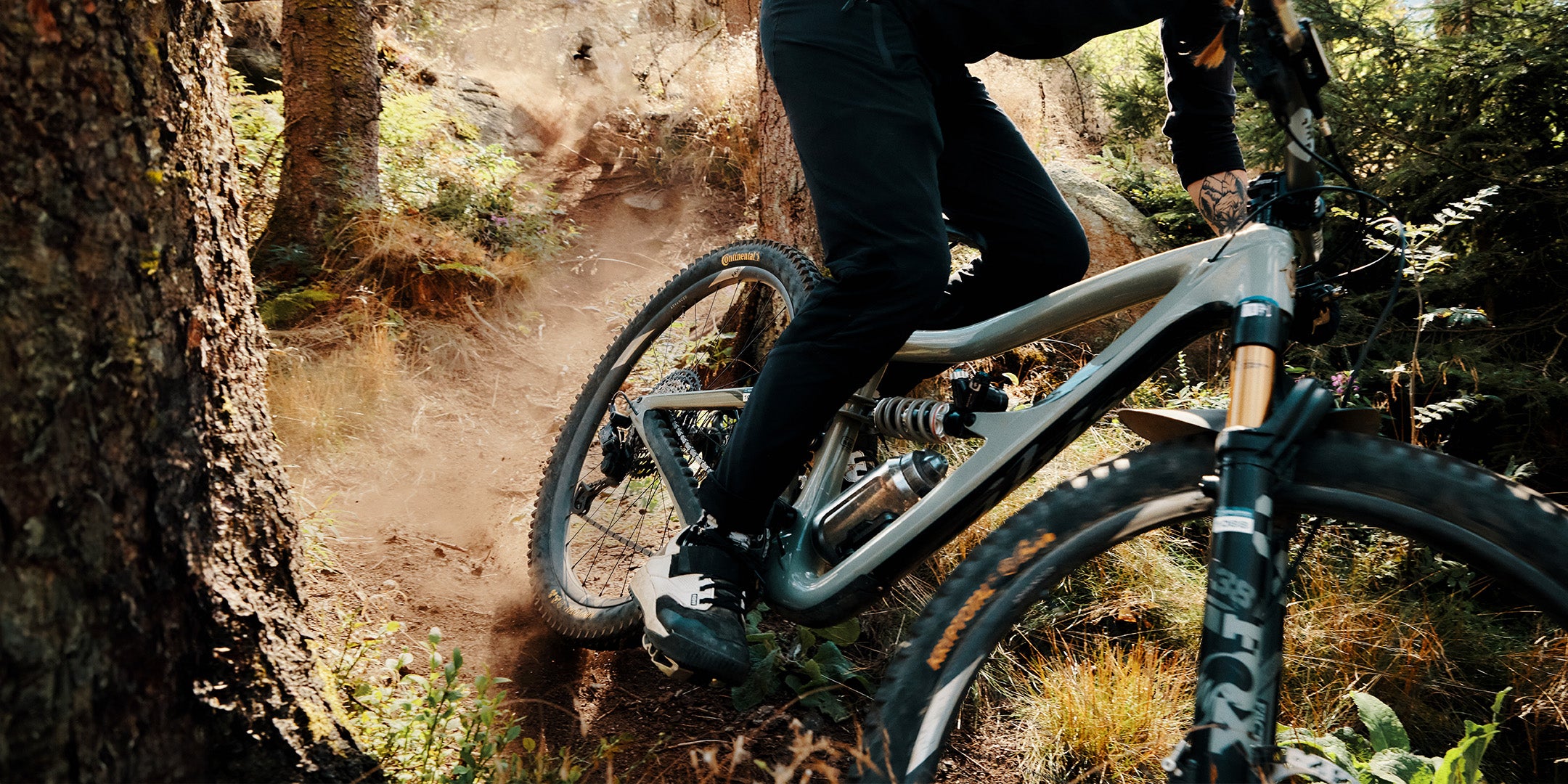 Fidlock magnetic locking water bottle on mountain bike being ridden down forest trail