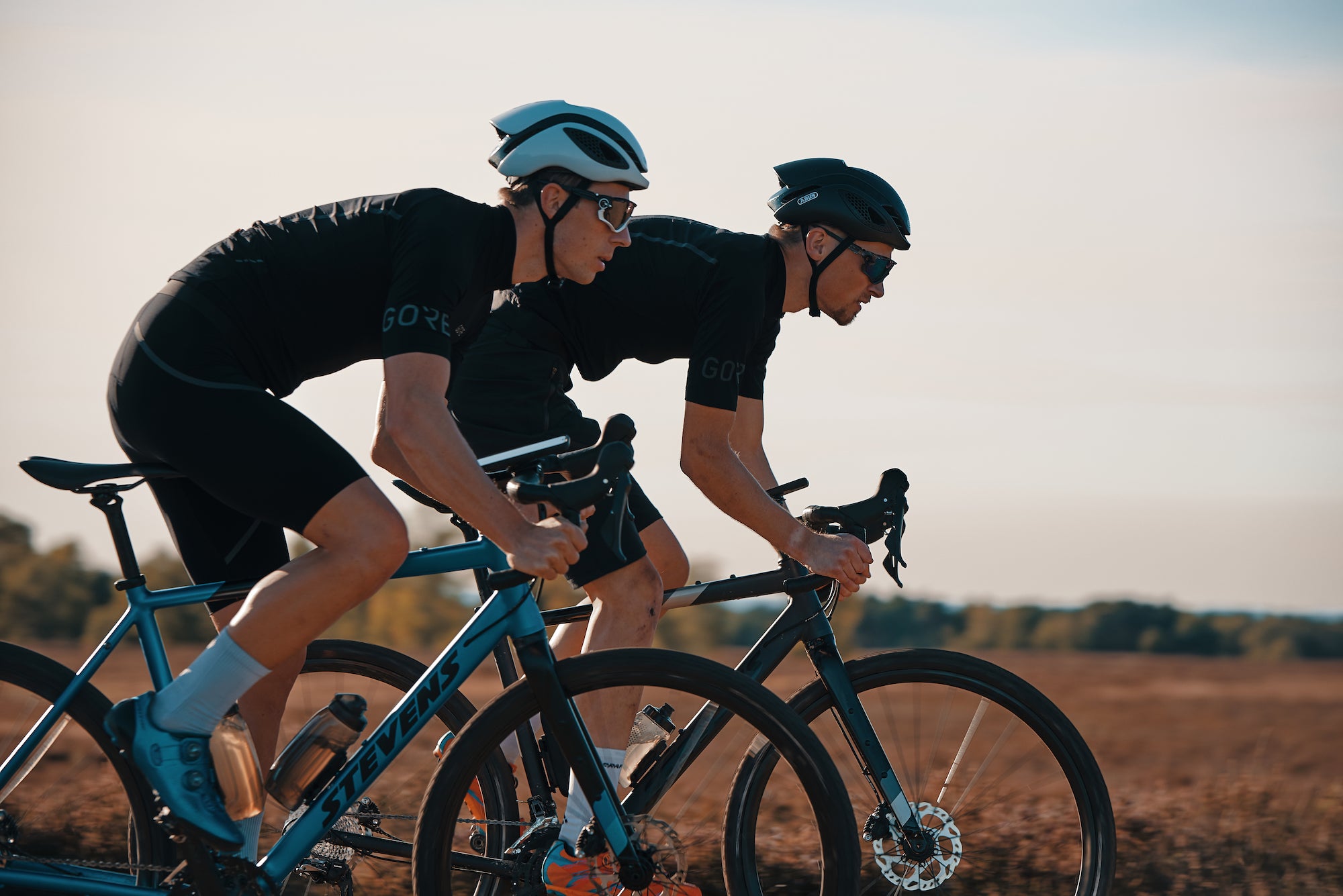 Road cyclists with Fidlock VACUUM phone mounting systems attached to their bikes